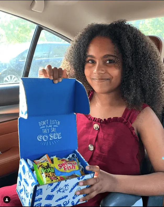 Girl holding candy sample box