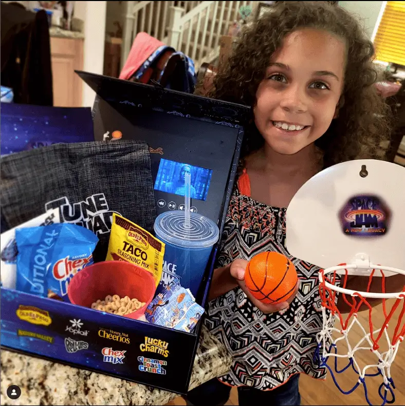 Girl displaying Space Jam sample box